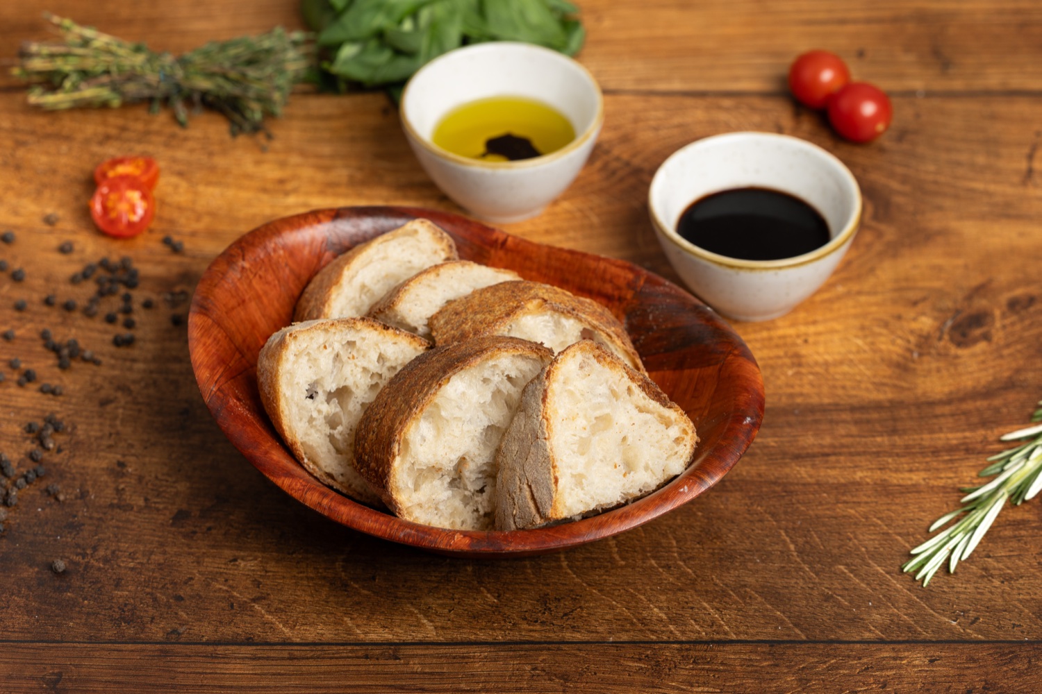 A basket of fresh bread baked daily at Saporitalia, with olive oil and balsamic